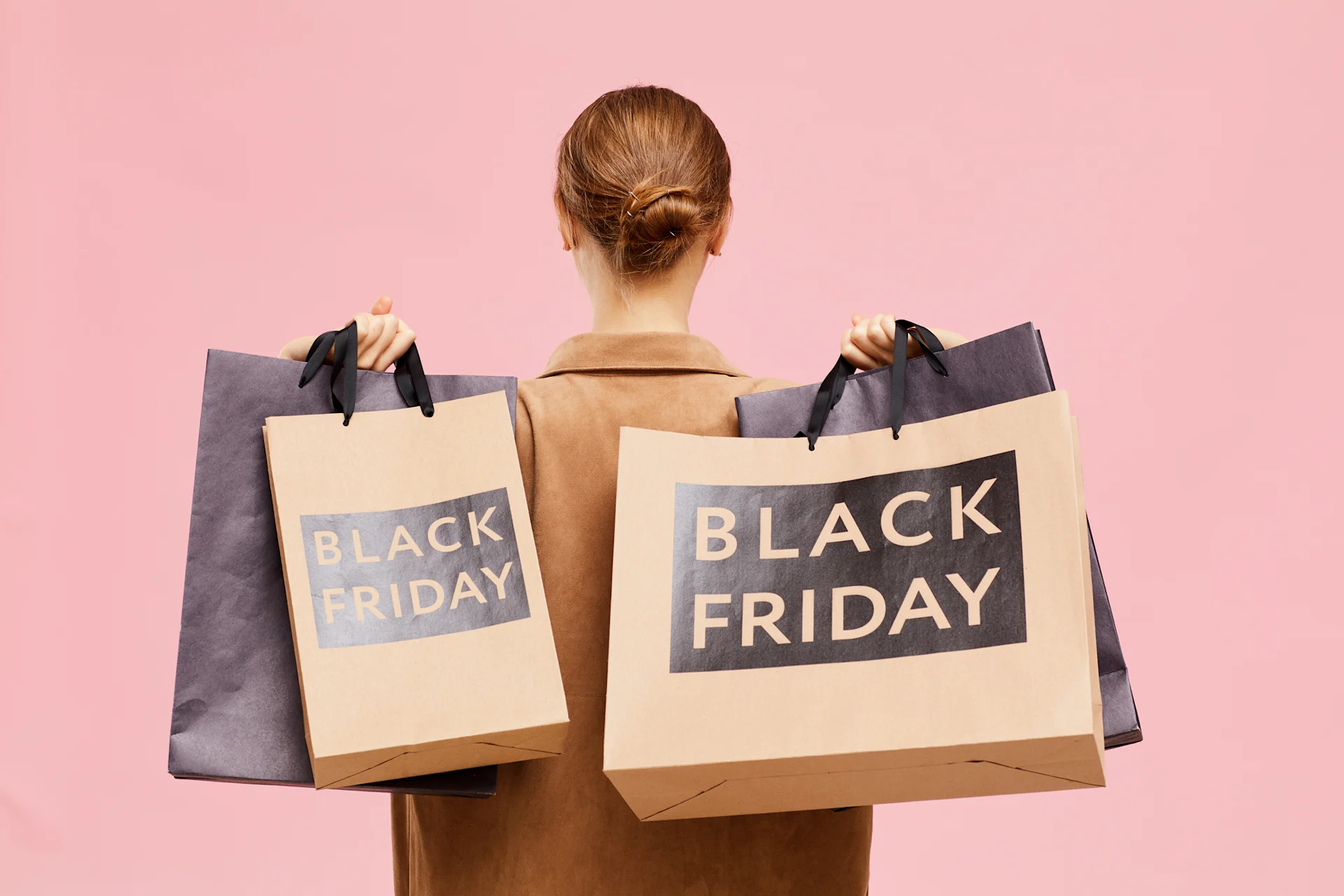 woman holding black friday shopping bags