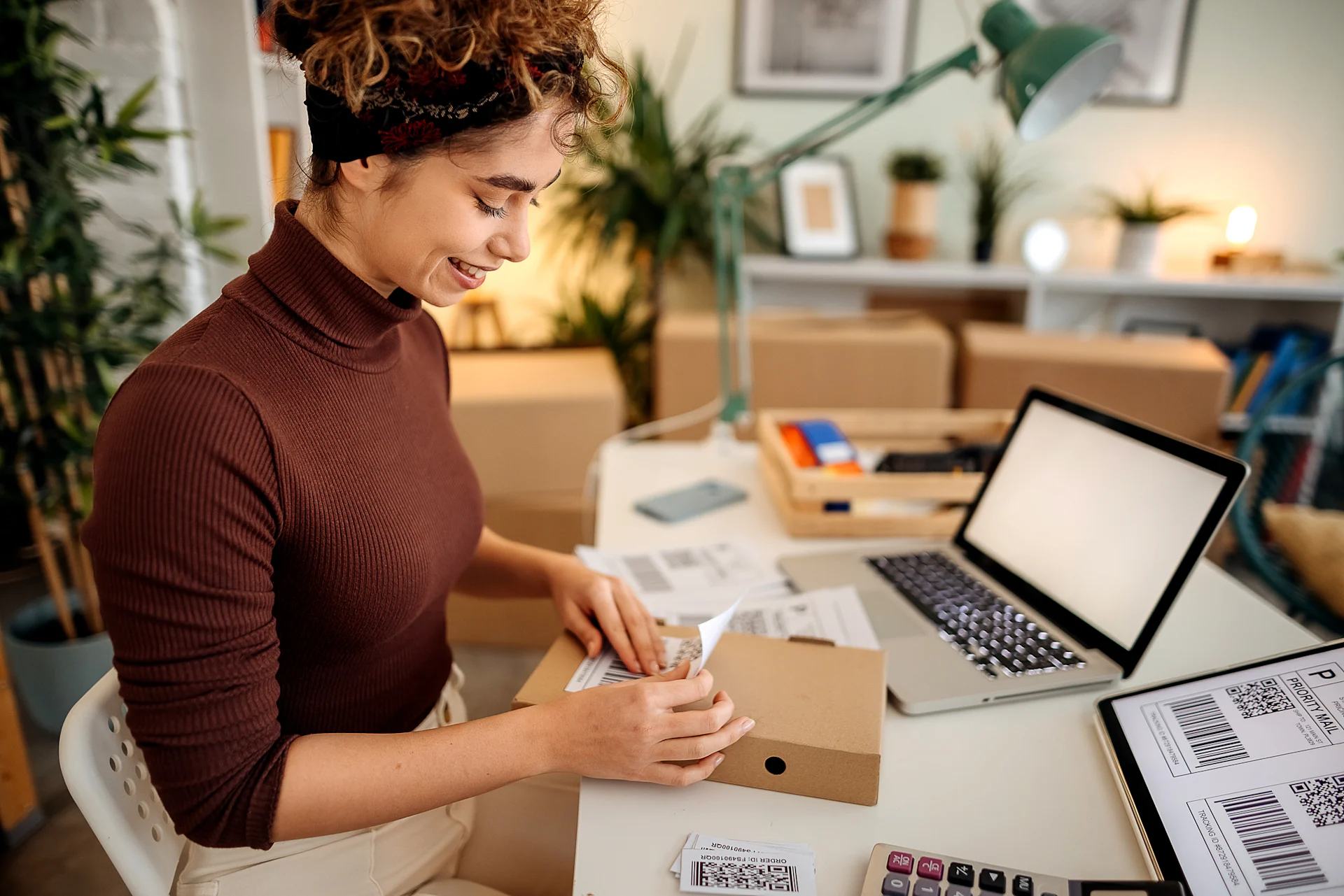 woman applying postage label to parcel