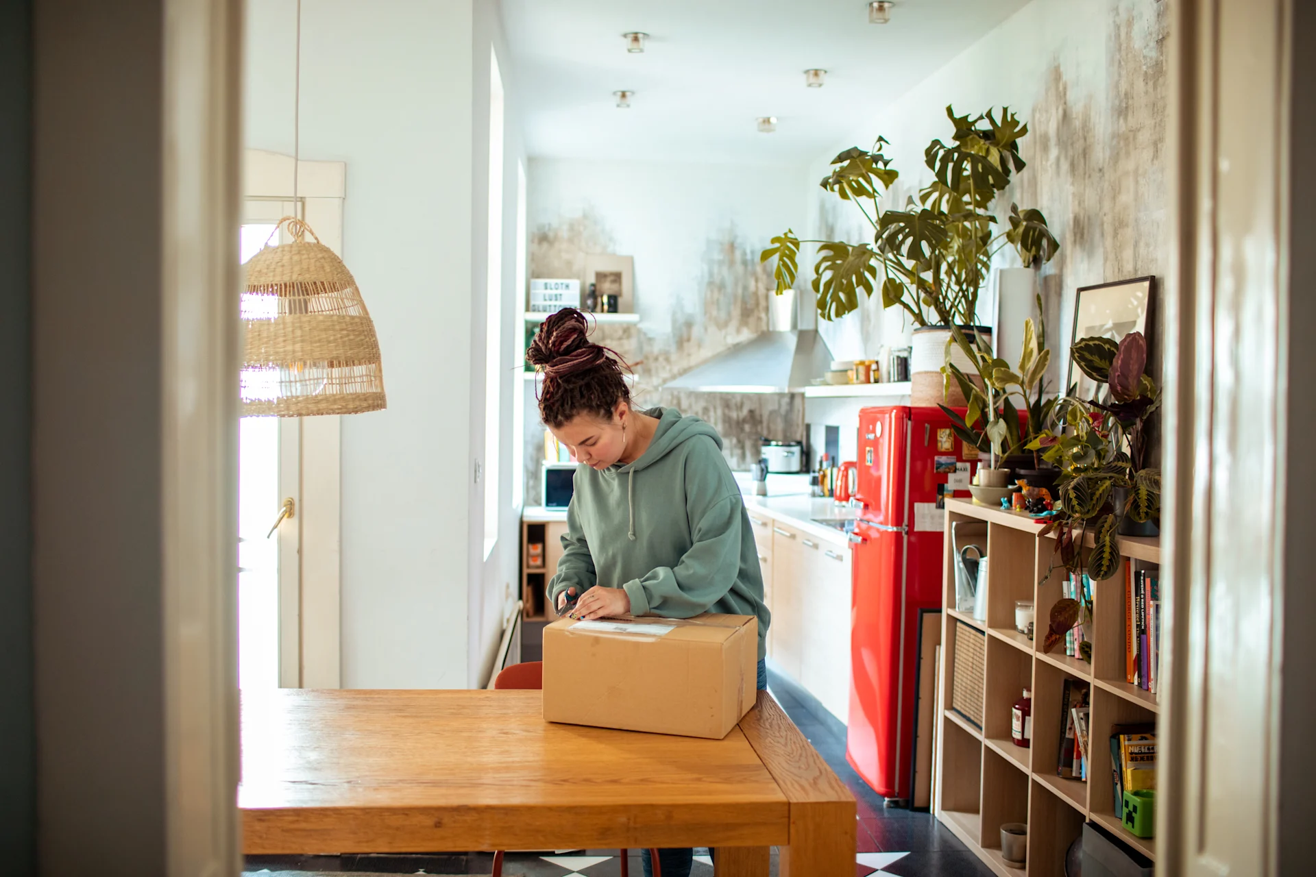 Woman packing parcel at home for delivery
