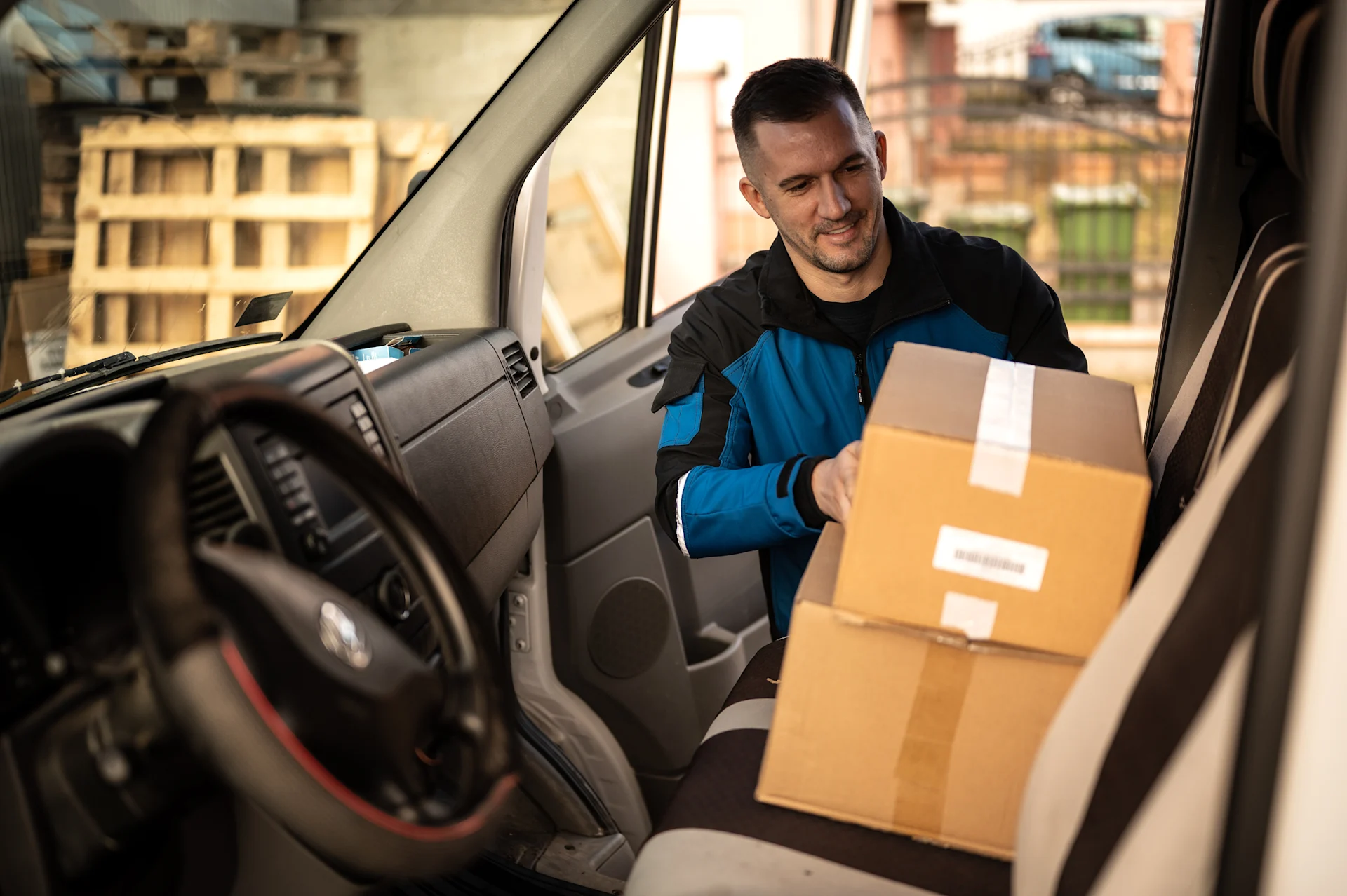 Delivery driver with parcel in van