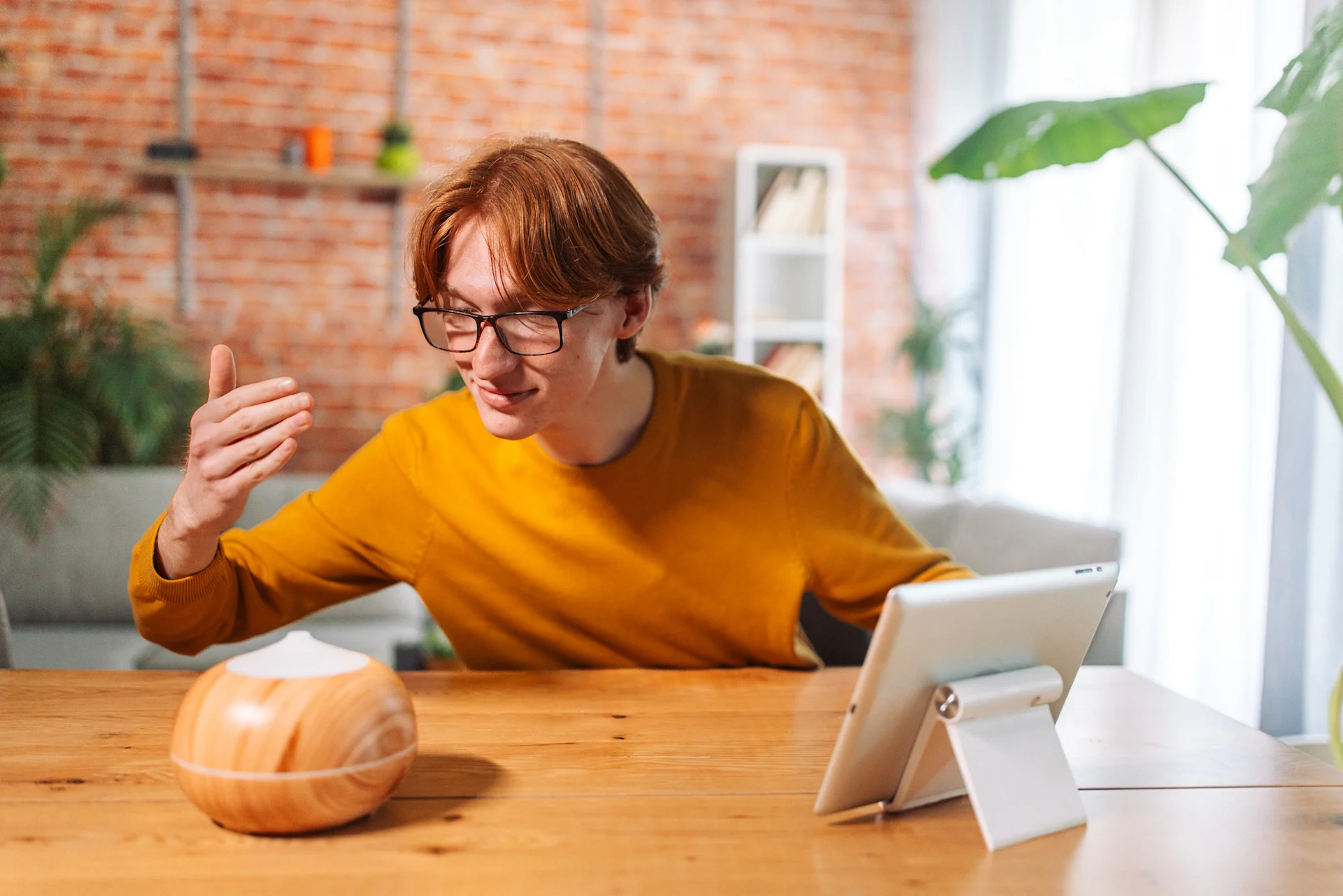 student on tablet while enjoying diffuser