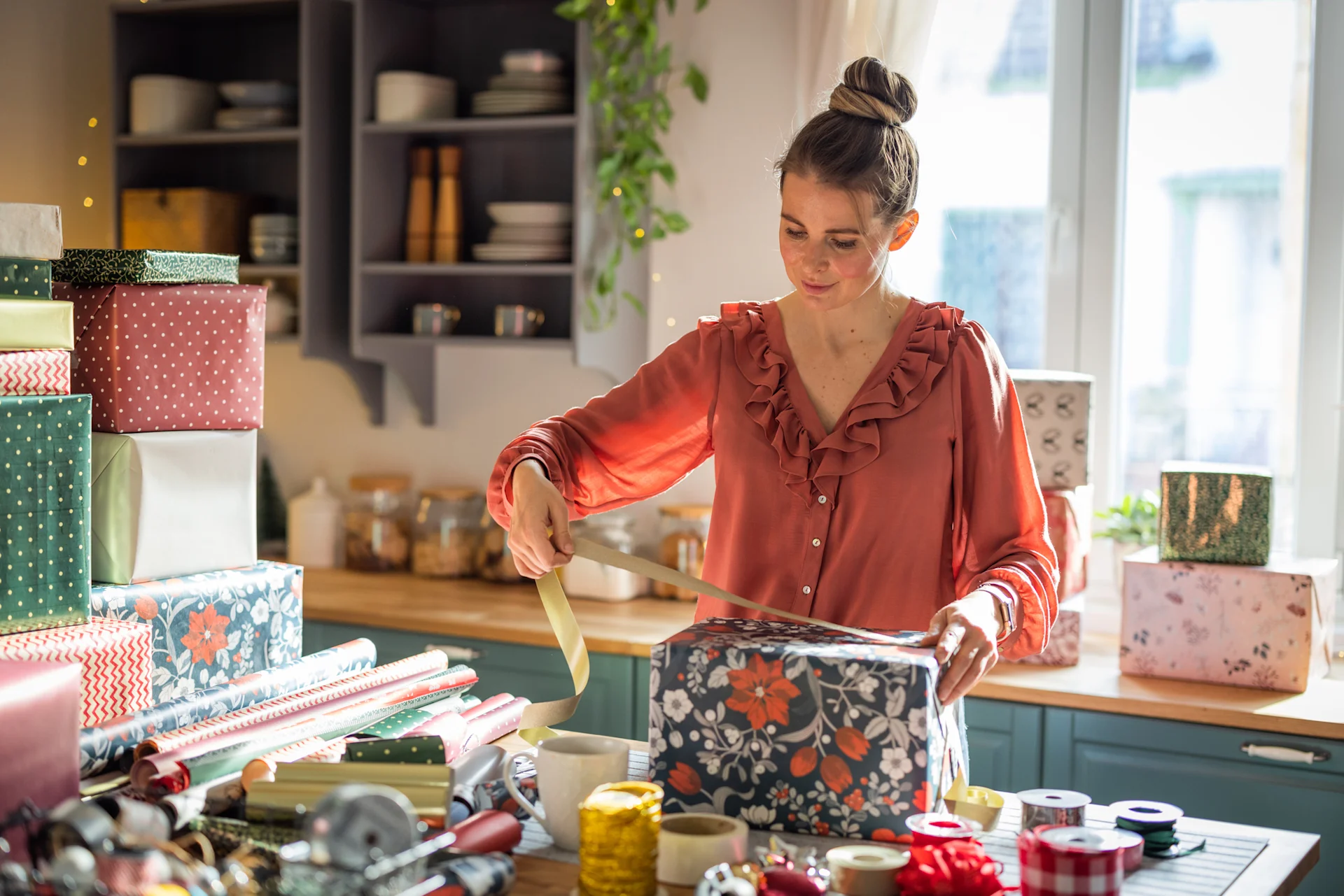 Woman packing christmas gift parcel