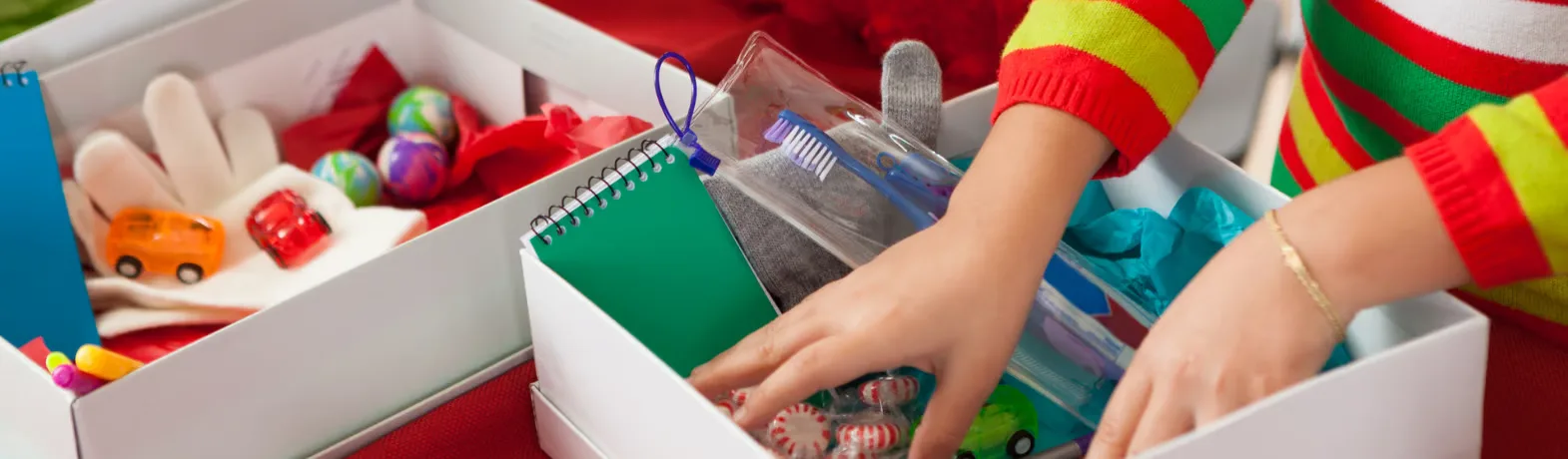 Person packing christmas shoebox