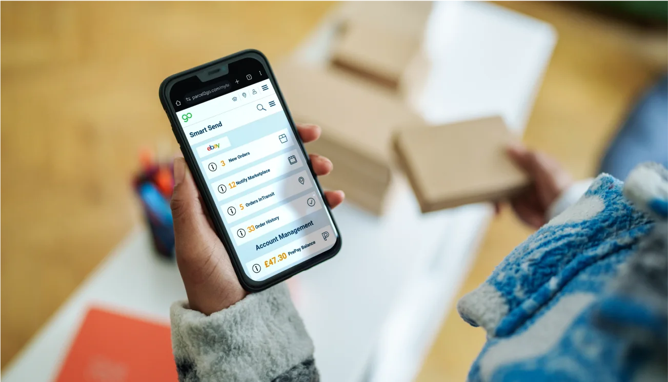 Woman's hand holding phone displaying Smart Send dashboard