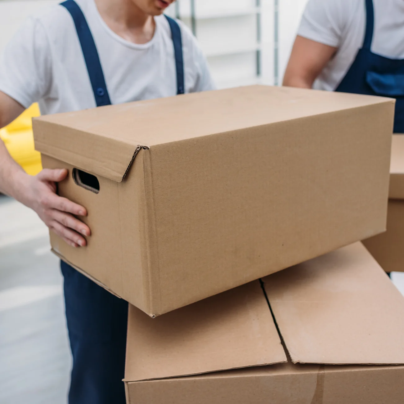 Delivery driver stacking 2 large boxes