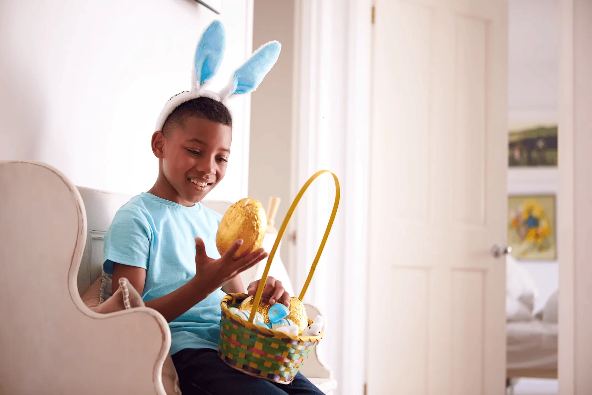 Child holding Easter basket and egg