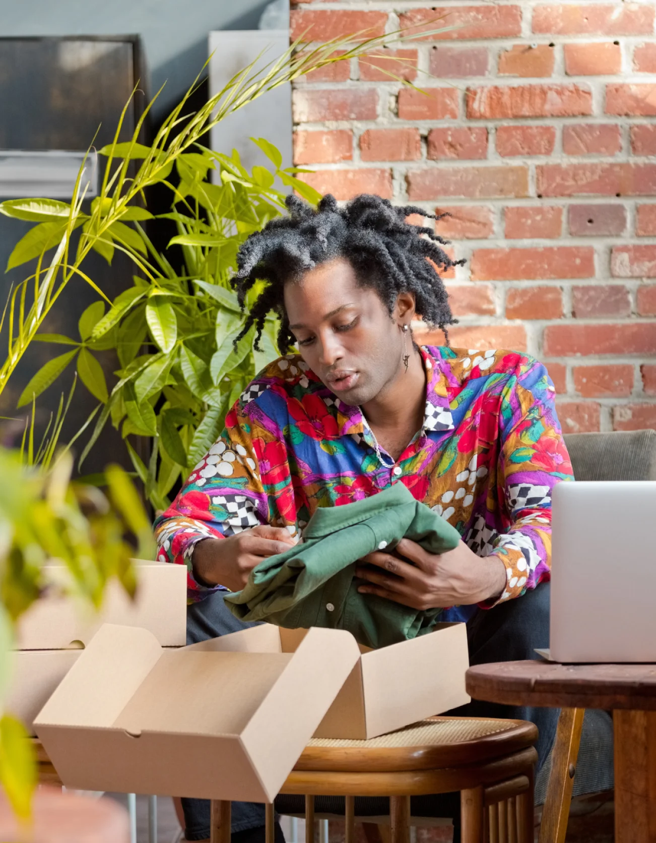 Man unpacking clothes from box
