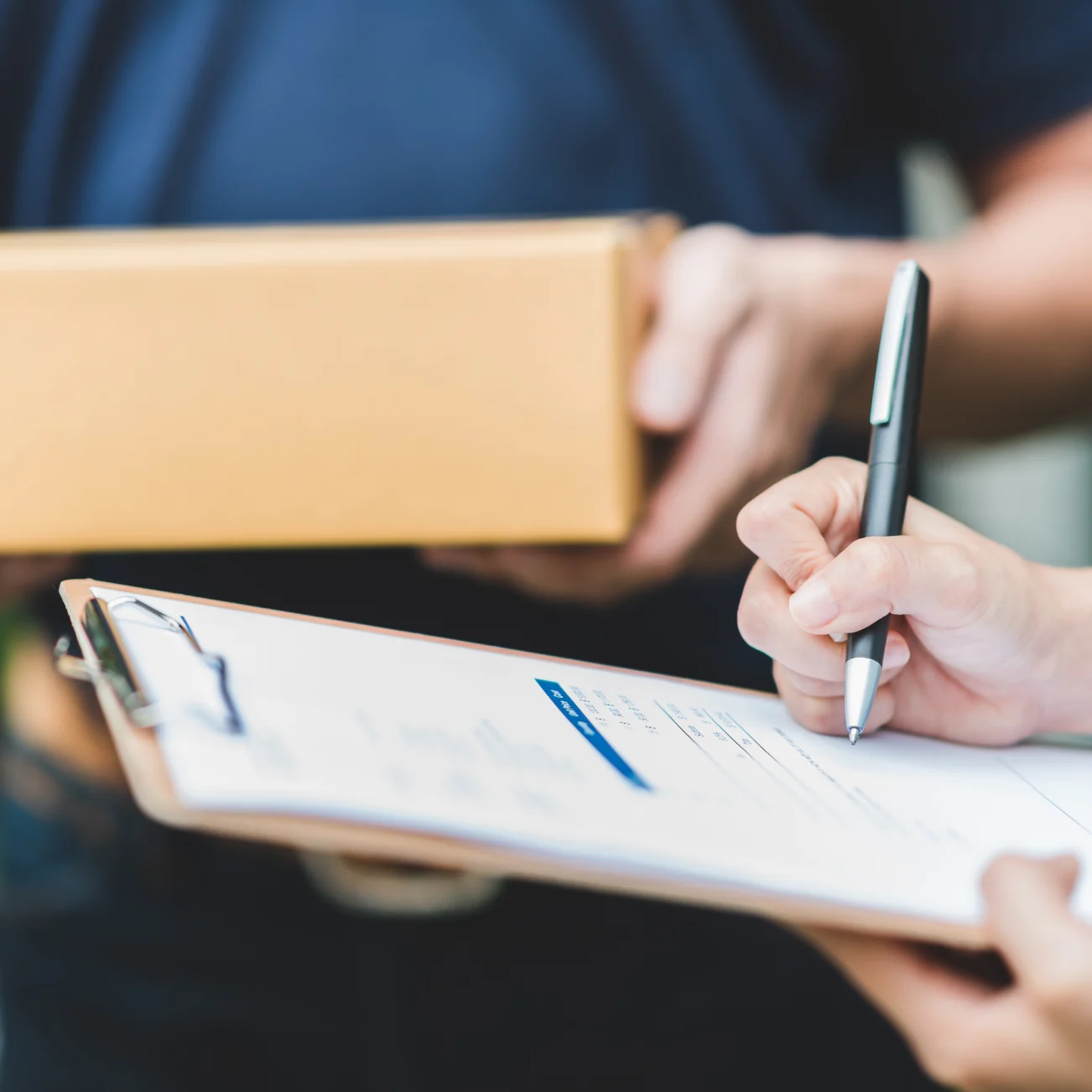 Person signing paper for delivery