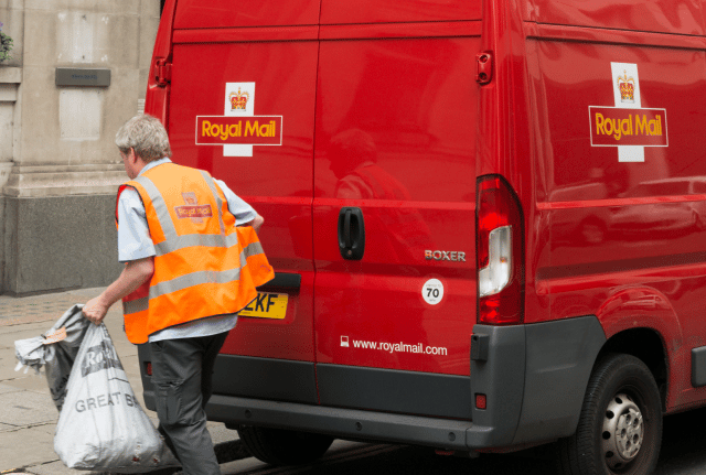 Royal Mail driver outside his van